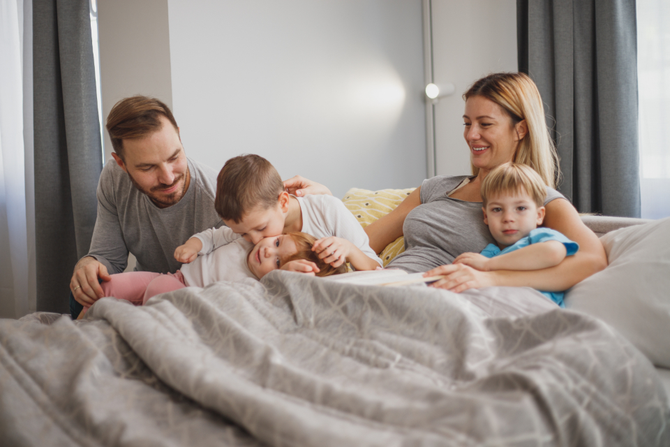 A warm, loving family with young children sharing a joyful moment together at home